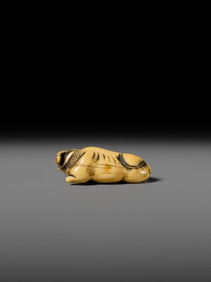 A GOOD KYOTO SCHOOL IVORY NETSUKE OF A RECUMBENT OX