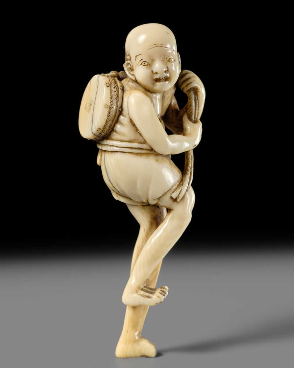 Lot 269 - GYOKUYOSAI: A FINE IVORY NETSUKE OF ASHINAGA WITH A DRUM
