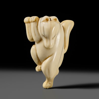 Lot 429 - AN IVORY NETSUKE OF A DANCING KITSUNE