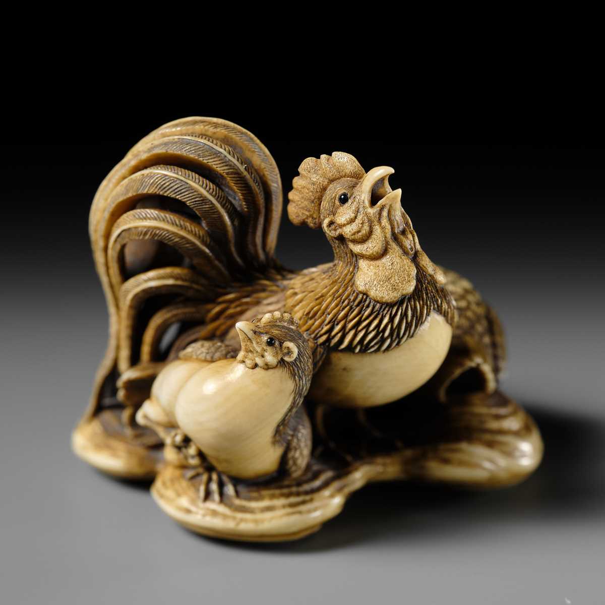Lot 165 - RANTEI: A SUPERB AND LARGE IVORY NETSUKE OF A COCKEREL WITH TWO HENS AND YOUNG