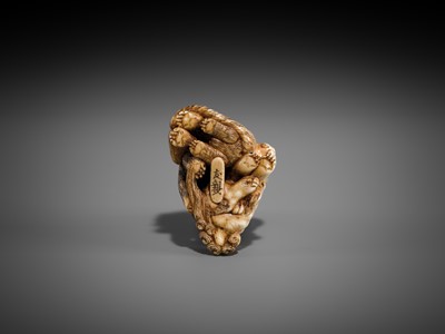 Lot 421 - TOMOCHIKA: AN IVORY NETSUKE OF A SHISHI, BEAR, AND TIGER