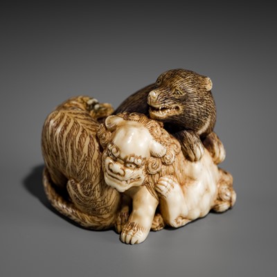 Lot 421 - TOMOCHIKA: AN IVORY NETSUKE OF A SHISHI, BEAR, AND TIGER