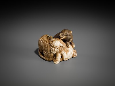 Lot 421 - TOMOCHIKA: AN IVORY NETSUKE OF A SHISHI, BEAR, AND TIGER