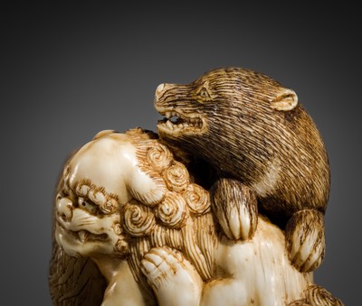 Lot 421 - TOMOCHIKA: AN IVORY NETSUKE OF A SHISHI, BEAR, AND TIGER