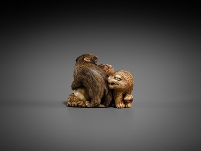 Lot 421 - TOMOCHIKA: AN IVORY NETSUKE OF A SHISHI, BEAR, AND TIGER