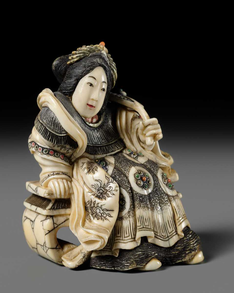 Lot 166 - ANRAKUSAI NOBUKUNI: A SUPERB INLAID IVORY NETSUKE OF SEIOBO