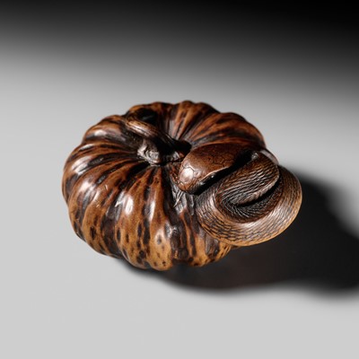 Lot 217 - TADAKUNI: A FINE NAGOYA SCHOOL WOOD NETSUKE OF SNAKE WINDING THROUGH A PUMPKIN