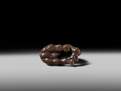 Lot 146 - A FINE WOOD NETSUKE OF A WOLF WITH HAUNCH OF VENISON, ATTRIBUTED TO OKATOMO