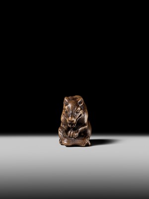 Lot 146 - A FINE WOOD NETSUKE OF A WOLF WITH HAUNCH OF VENISON, ATTRIBUTED TO OKATOMO