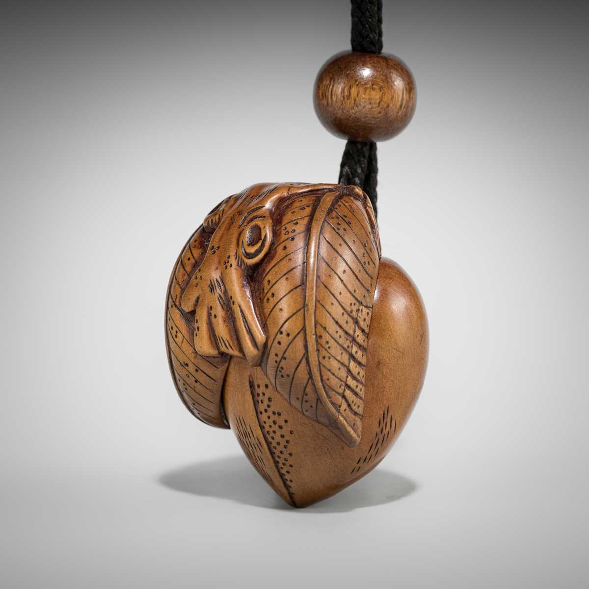 Lot 476 - A RARE WOOD SHUNGA NETSUKE OF A PEACH ON A