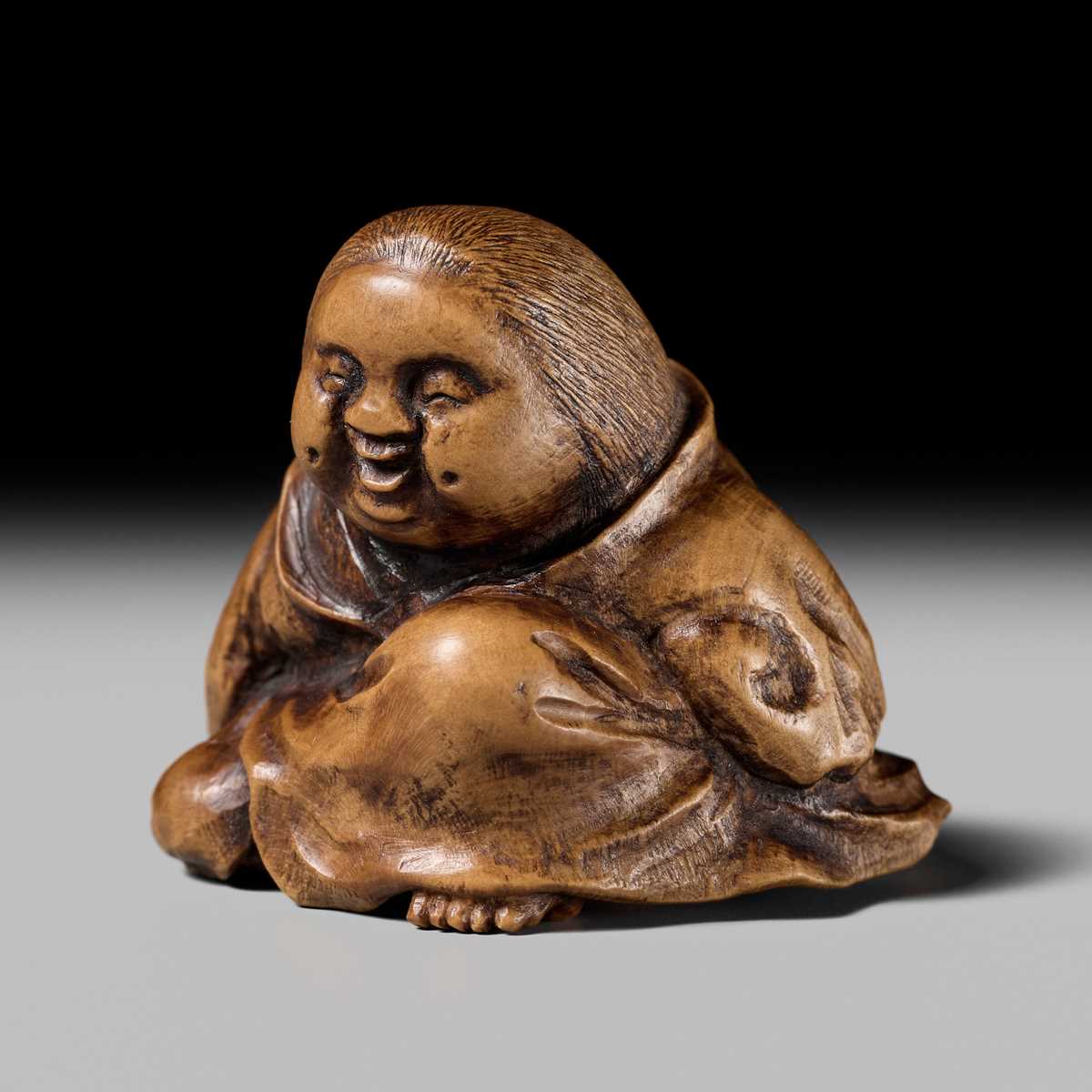 Lot 302 - A WOOD SHUNGA NETSUKE OF OKAME