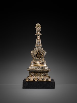 Lot 32 - A LARGE GILT-BRONZE STUPA CONTAINING A FIGURE OF BUDDHA SHAKYAMUNI, TIBET, LATE 19TH TO FIRST HALF OF THE 20TH CENTURY