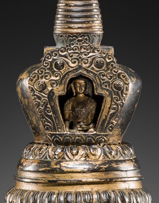 Lot 32 - A LARGE GILT-BRONZE STUPA CONTAINING A FIGURE OF BUDDHA SHAKYAMUNI, TIBET, LATE 19TH TO FIRST HALF OF THE 20TH CENTURY