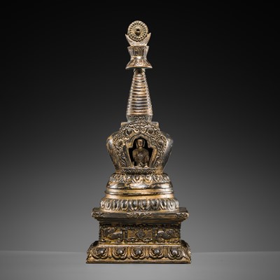 Lot 32 - A LARGE GILT-BRONZE STUPA CONTAINING A FIGURE OF BUDDHA SHAKYAMUNI, TIBET, LATE 19TH TO FIRST HALF OF THE 20TH CENTURY