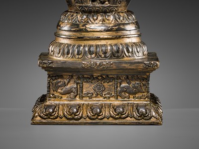 Lot 32 - A LARGE GILT-BRONZE STUPA CONTAINING A FIGURE OF BUDDHA SHAKYAMUNI, TIBET, LATE 19TH TO FIRST HALF OF THE 20TH CENTURY
