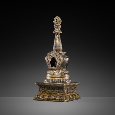 Lot 32 - A LARGE GILT-BRONZE STUPA CONTAINING A FIGURE OF BUDDHA SHAKYAMUNI, TIBET, LATE 19TH TO FIRST HALF OF THE 20TH CENTURY