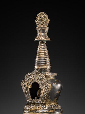 Lot 32 - A LARGE GILT-BRONZE STUPA CONTAINING A FIGURE OF BUDDHA SHAKYAMUNI, TIBET, LATE 19TH TO FIRST HALF OF THE 20TH CENTURY