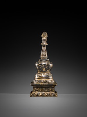 Lot 32 - A LARGE GILT-BRONZE STUPA CONTAINING A FIGURE OF BUDDHA SHAKYAMUNI, TIBET, LATE 19TH TO FIRST HALF OF THE 20TH CENTURY