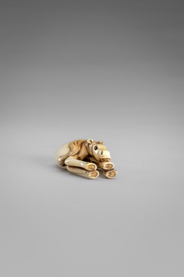 Lot 499 - AN IVORY NETSUKE OF A GRAZING HORSE