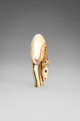 Lot 499 - AN IVORY NETSUKE OF A GRAZING HORSE