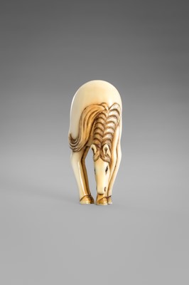 Lot 499 - AN IVORY NETSUKE OF A GRAZING HORSE