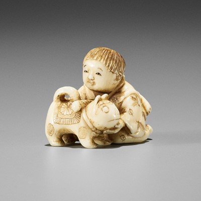Lot 1612 - JUGYOKU: A CHARMING SMALL IVORY NETSUKE OF A BOY WITH DOG TOY