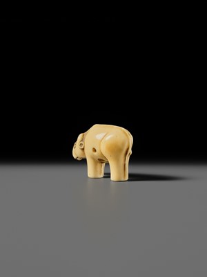 Lot 159 - OHARA MITSUSADA: AN IVORY NETSUKE OF AN OX-FORM OMAMORI