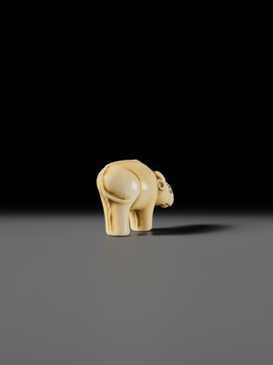 Lot 159 - OHARA MITSUSADA: AN IVORY NETSUKE OF AN OX-FORM OMAMORI