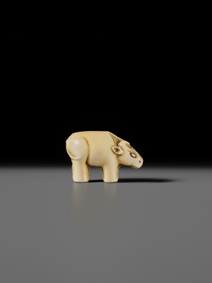 Lot 159 - OHARA MITSUSADA: AN IVORY NETSUKE OF AN OX-FORM OMAMORI
