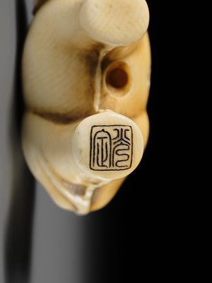 Lot 159 - OHARA MITSUSADA: AN IVORY NETSUKE OF AN OX-FORM OMAMORI