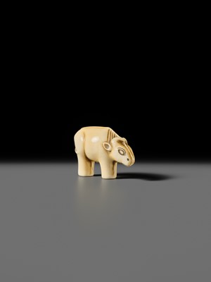 Lot 159 - OHARA MITSUSADA: AN IVORY NETSUKE OF AN OX-FORM OMAMORI
