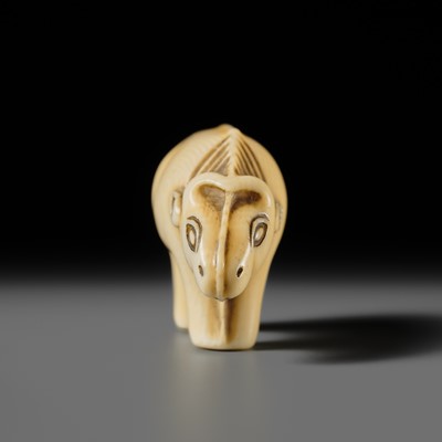 Lot 159 - OHARA MITSUSADA: AN IVORY NETSUKE OF AN OX-FORM OMAMORI