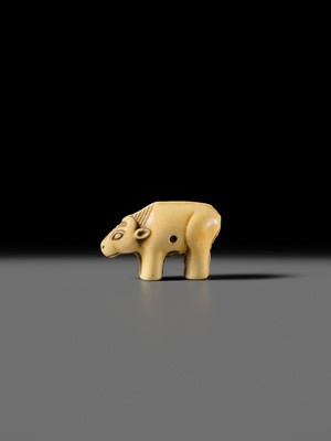 Lot 159 - OHARA MITSUSADA: AN IVORY NETSUKE OF AN OX-FORM OMAMORI