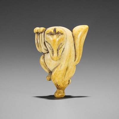 Lot 1491 - AN IVORY NETSUKE OF A DANCING KITSUNE
