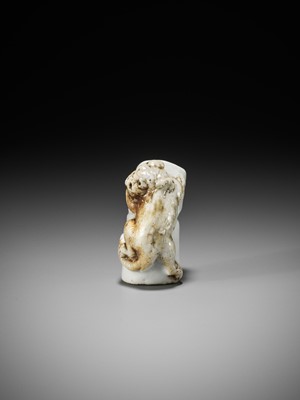 Lot 559 - A HIRADO PORCELAIN NETSUKE OF A TIGER ON BAMBOO