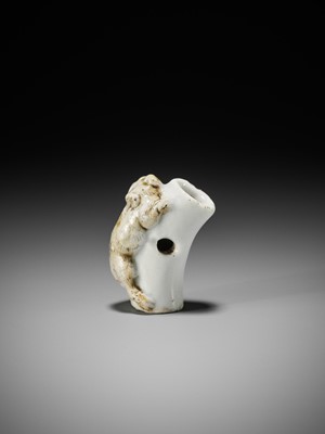 Lot 559 - A HIRADO PORCELAIN NETSUKE OF A TIGER ON BAMBOO