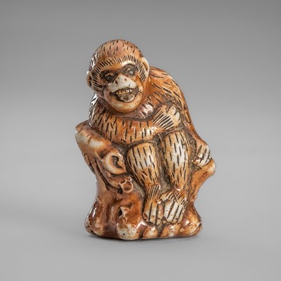 Lot 1779 - A CHARMING HIRADO PORCELAIN NETSUKE OF A MONKEY