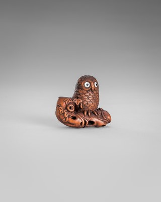 Lot 374 - IKKYU: A WOOD NETSUKE OF AN OWL WITH A MOVABLE OWLET