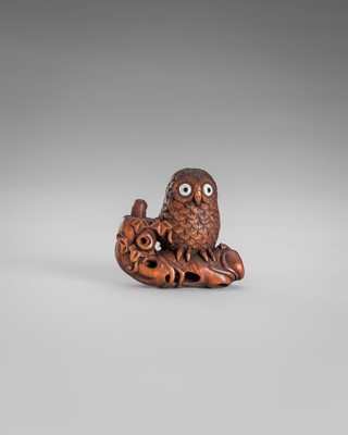 Lot 374 - IKKYU: A WOOD NETSUKE OF AN OWL WITH A MOVABLE OWLET
