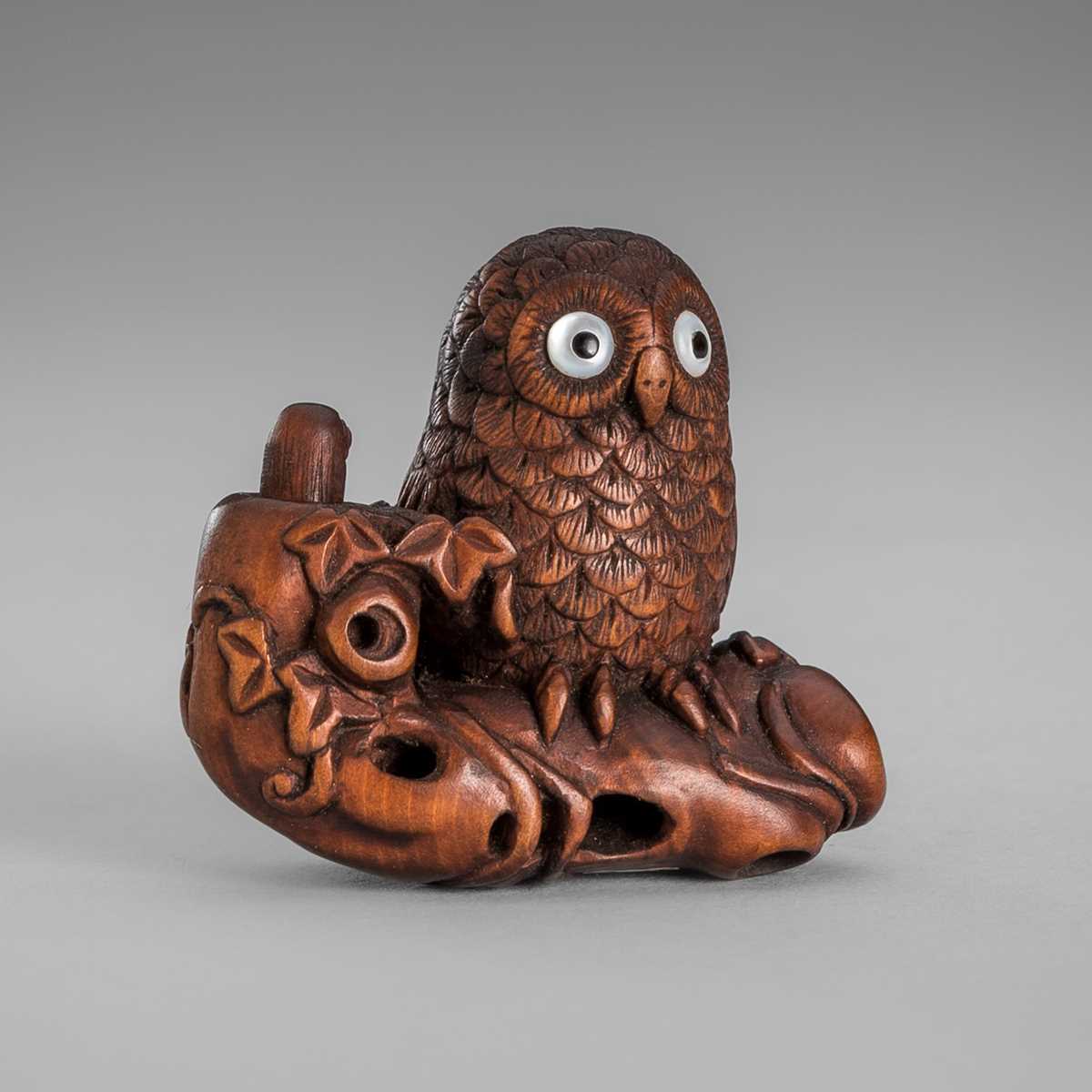 Lot 374 - IKKYU: A WOOD NETSUKE OF AN OWL WITH A MOVABLE OWLET