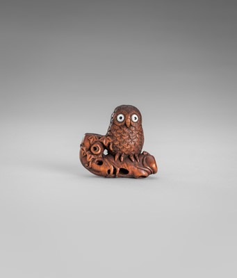 Lot 374 - IKKYU: A WOOD NETSUKE OF AN OWL WITH A MOVABLE OWLET
