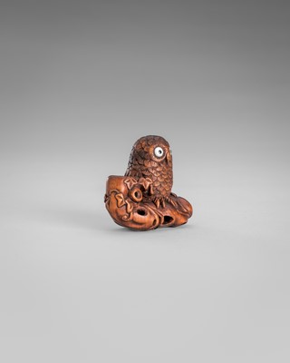 Lot 374 - IKKYU: A WOOD NETSUKE OF AN OWL WITH A MOVABLE OWLET