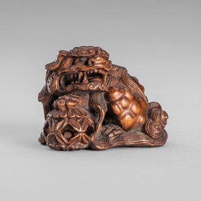 Lot 1643 - HOGEN HIROAKI: A FINE WOOD NETSUKE OF A SHISHI WITH A BALL
