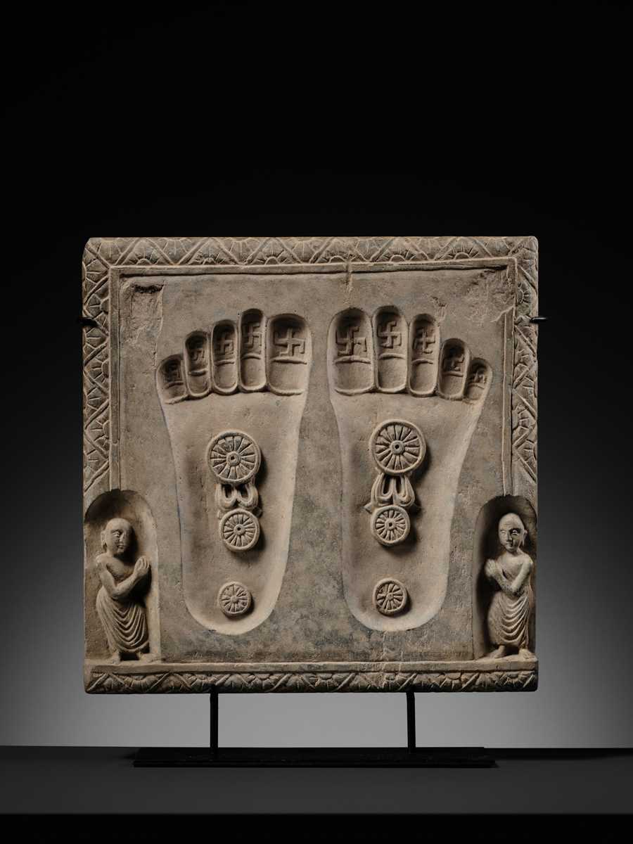 Lot 187 - A SCHIST RELIEF OF THE FOOTPRINTS OF BUDDHA,