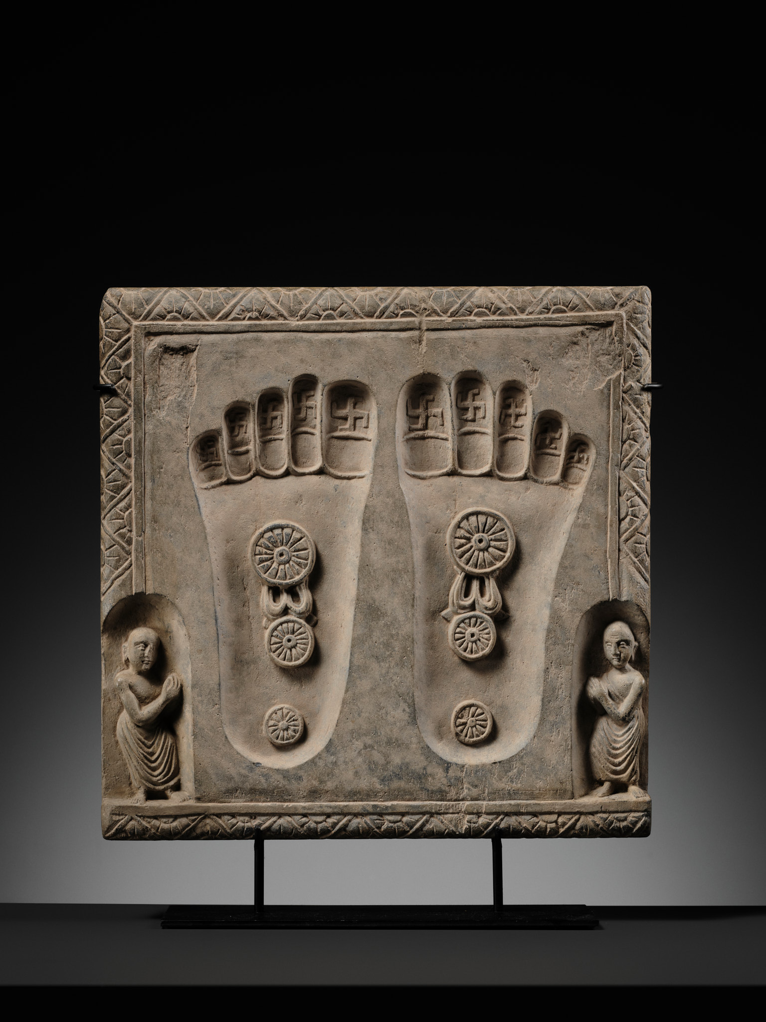 Lot 187 - A SCHIST RELIEF OF THE FOOTPRINTS OF BUDDHA,