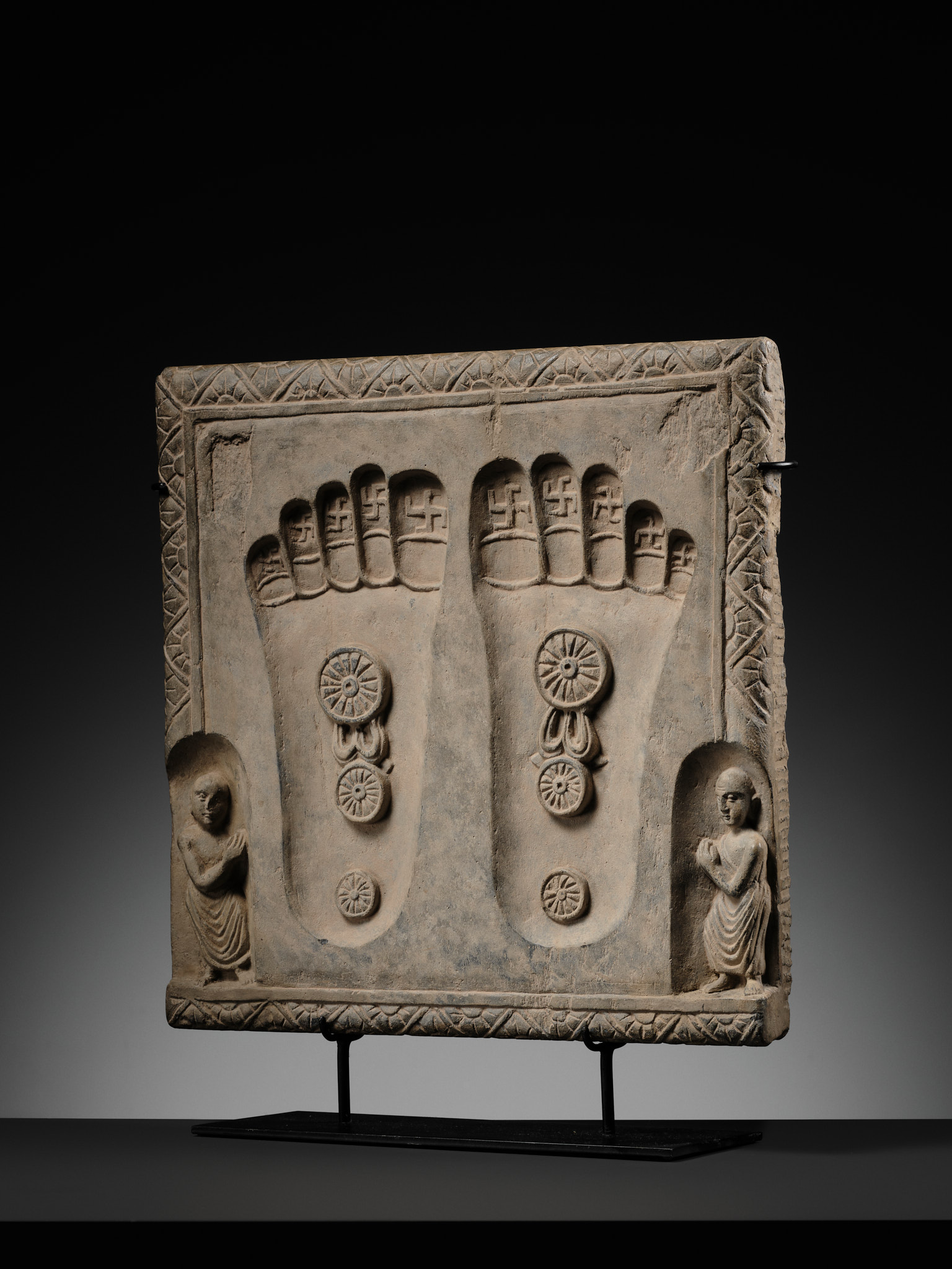Lot 187 - A SCHIST RELIEF OF THE FOOTPRINTS OF BUDDHA,