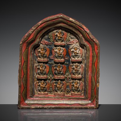 Lot 130 - A GILT AND POLYCHROME WOOD PORTABLE SHRINE WITH A CLAY TSA-TSA DEPICTING TEN MANJUSHRI