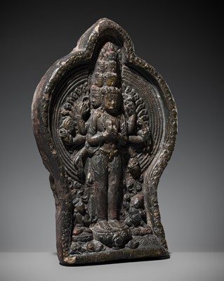 Lot 129 - A LARGE LACQUERED CLAY TSA-TSA DEPICTING EKADASAMUKHA AVALOKITESHVARA, TIBET, 18TH CENTURY