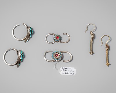 Lot 268 - A GROUP WITH THREE PAIRS OF SILVER ORNAMENTS, HIMALAYAN REGION