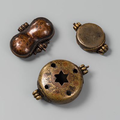 Lot 226 - A GROUP OF THREE BRASS AND COPPER CHARM BOXES, GAU, 18TH-19TH CENTURY